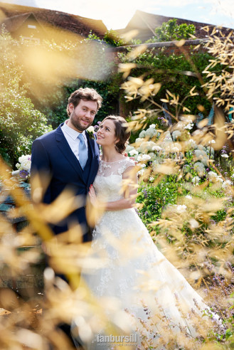 Braxted Park Ian Bursill wedding photographer couple through foliage